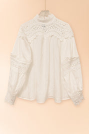 Hanger flatlay, front view of the white high-neck blouse showing the lace yoke and sleeve lace bands with scalloped edge.