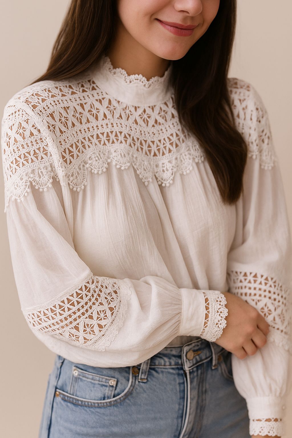 Left three-quarter view of the white lace-yoke high-neck blouse showing the sleeve lace bands and straight rounded hem