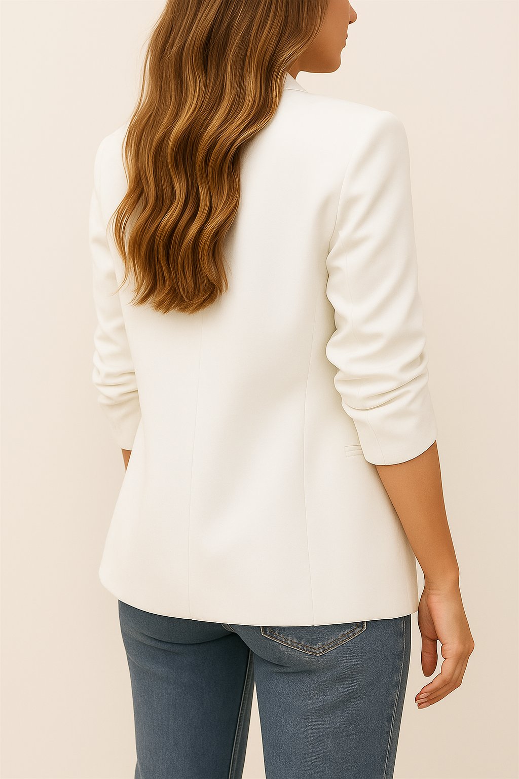 Back view of the white longline blazer with a clean back panel and straight hem.