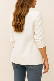 Back view of the white longline blazer with a clean back panel and straight hem.