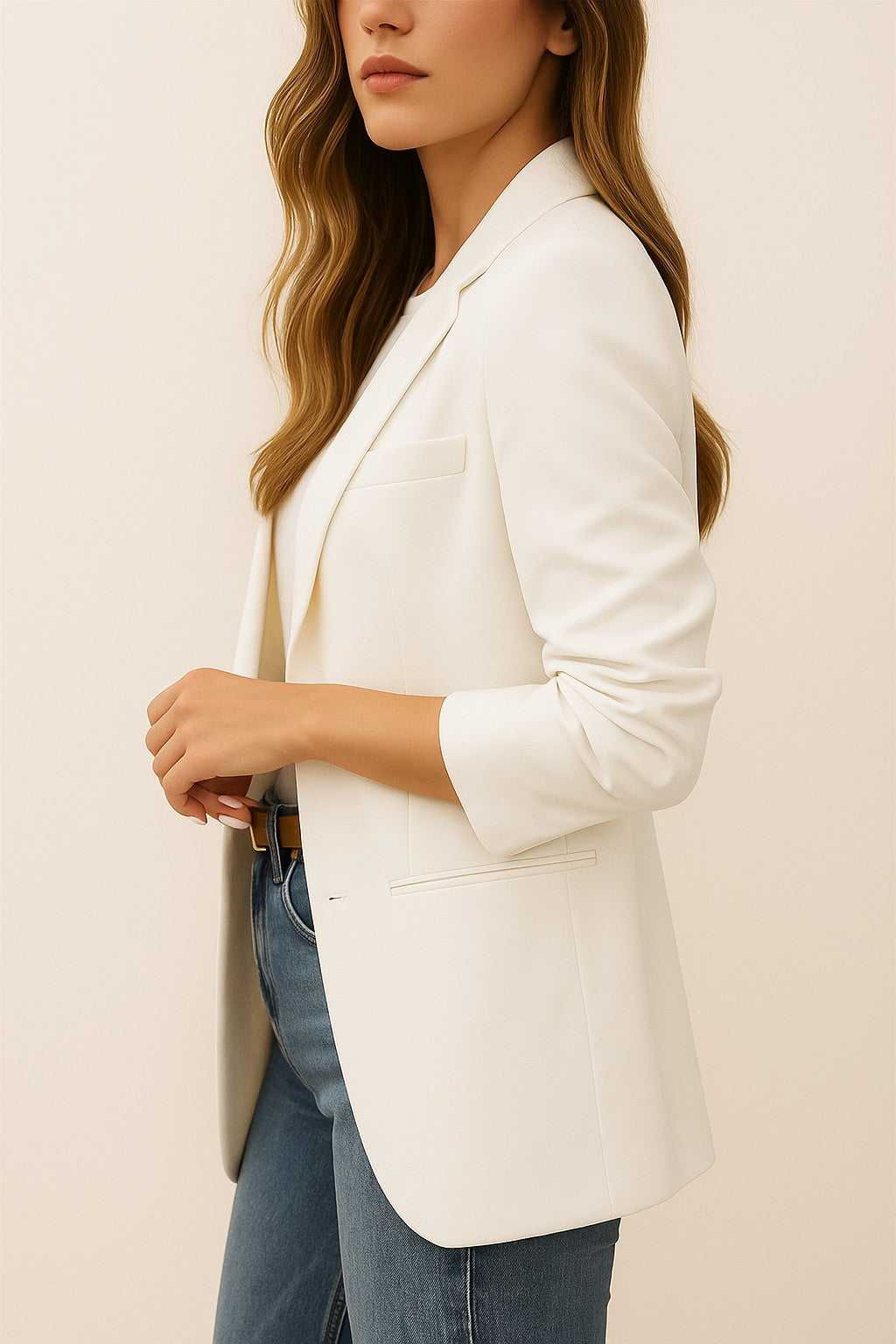 Left side view of the white longline blazer showing the notched lapel and welt pocket detail.