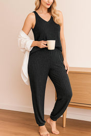 Women's black ribbed knit pajama set with sleeveless top and cuffed lounge pants, soft and cozy homewear