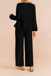 Back view of the black tie-front peplum blouse and wide-leg pants set with straight hem.