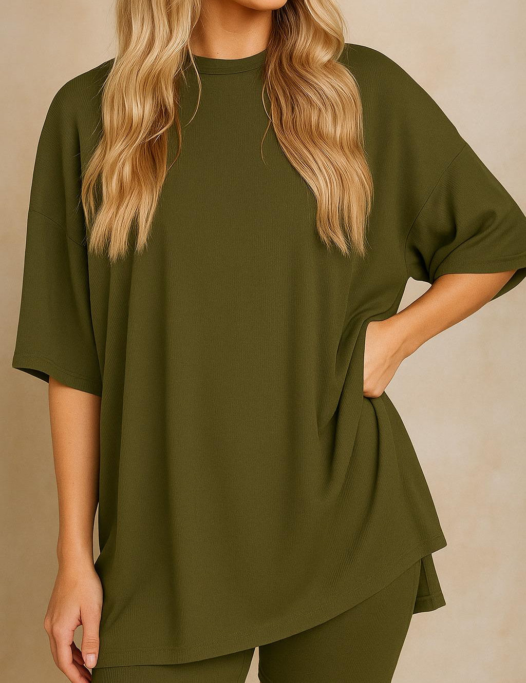 Plus size woman wearing an oversized olive green lounge set with round neck top and matching shorts
