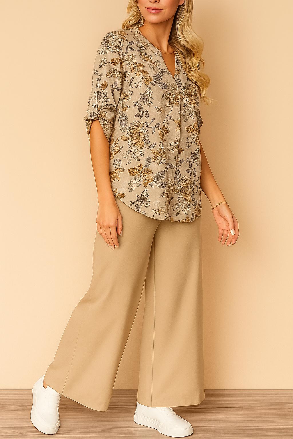 Front three-quarter view of the apricot floral split V-neck blouse paired with beige wide-leg pants; relaxed, above-ankle length.