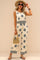 Front view of a women’s beige sleeveless printed two-piece set: scoop-neck top with drawstring waist and matching wide-leg pants with an elastic waist; black boho motif.