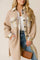 Front view of a women’s beige teddy longline button-up coat with plaid contrast collar/cuffs/yoke, flap chest pockets, slant hand pockets, drop-shoulder sleeves and side slits.