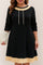 Front view of a women’s black A-line dress with beige contrast trim at the neckline and hem, drawstring neckline and three-quarter sleeves; above-knee length.