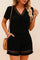 Front view of a black eyelet-trim V-neck short-sleeve top with matching shorts featuring side pockets and hem eyelet bands