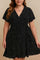 Plus-size black polka-dot wrap mini dress with V-neck, flutter sleeves and tie waist — front view