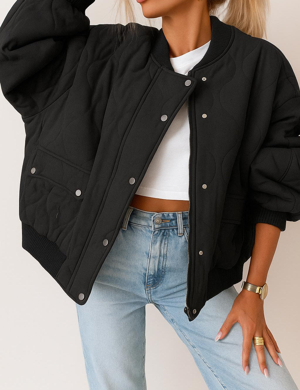 Front view of the black quilted bomber jacket with rib-knit collar and cuffs, zip front with snap placket, and snap-flap hip pockets.
