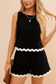 Front view of a women’s black ric-rac trim two-piece set with a sleeveless tank, high-waist shorts and side pockets; white wave trim at hem