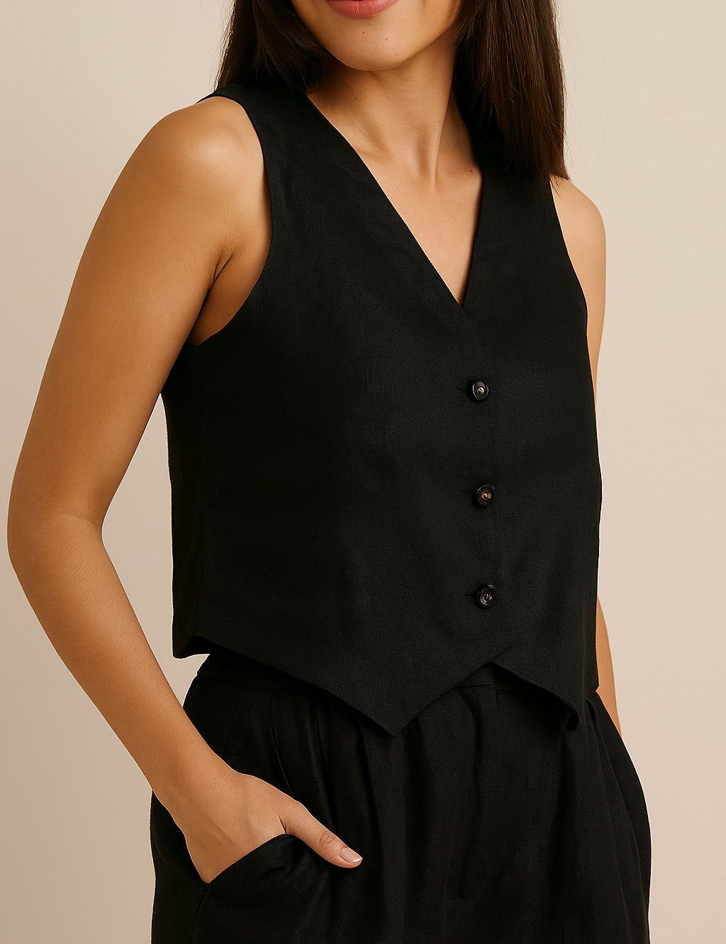 Front detail view of the black sleeveless vest and wide-leg pants set; V-neck and buttons