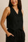 Front detail view of the black sleeveless vest and wide-leg pants set; V-neck and buttons
