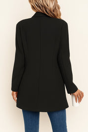 Back view of the black tailored coat showing clean panel seams, structured shoulders and a straight hem.