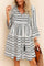 Black-and-white boho-print tie-neck mini dress with tassel ties, three-quarter sleeves and tiered skirt — seated front view