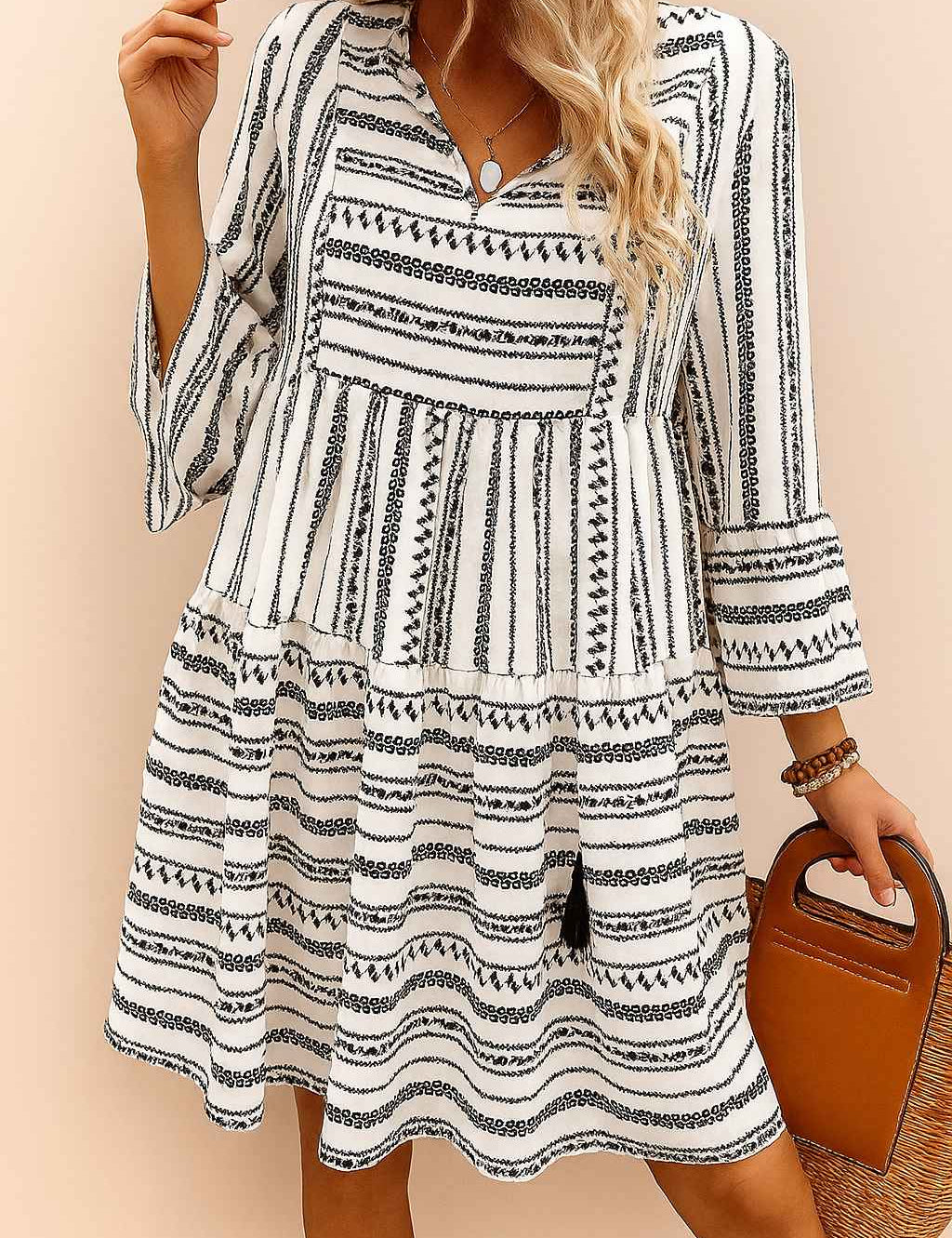 Black-and-white boho-print tie-neck mini dress with three-quarter sleeves and tiered skirt, lightweight drape — relaxed front view