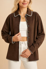 Centered front view of the brown faux-suede button-up shirt jacket with contrast stitch trim and button placket.