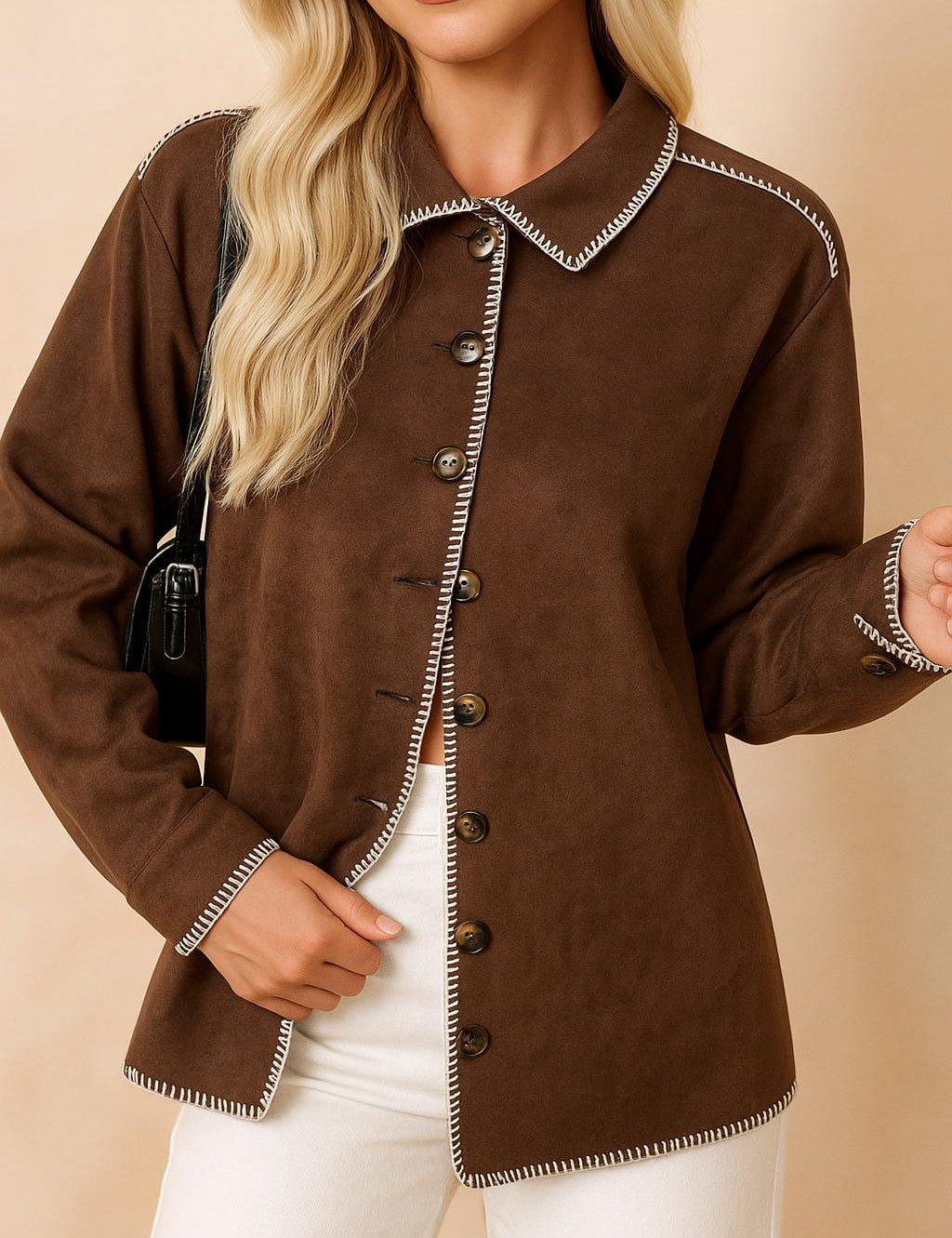Front view of a women’s brown faux-suede button-up shirt jacket with contrast whipstitch trim along the collar, placket, cuffs and hem; long sleeves and a rounded straight hem.