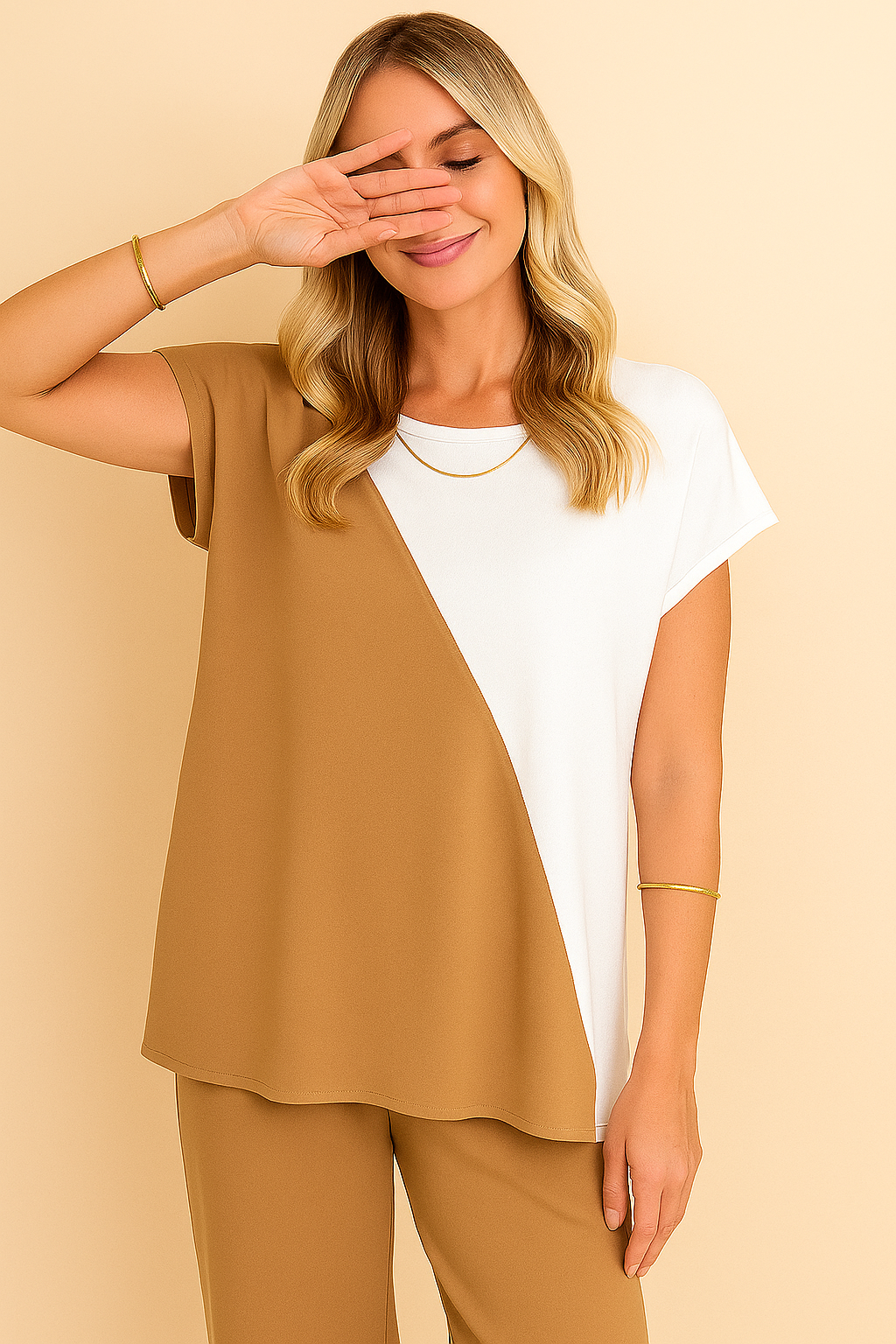 “Front three-quarter view of the camel two-tone round-neck top and wide-leg pants set showing the diagonal colorblock panel and relaxed drape.