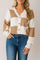Front view of a women’s caramel and ivory colorblock knit V-neck button-up cardigan with drop-shoulder sleeves and ribbed cuffs and hem.