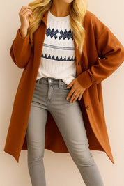 Centered front view of the caramel textured button-down collared longline coat; drop-shoulder sleeves and relaxed fit visible.