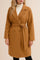 Front view of a women’s caramel tie-waist longline coat with notched lapel, double-breasted front, drop-shoulder long sleeves and slant welt pockets; straight rounded hem