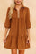 Front view of a women’s chevron-textured mini dress with a collared half-zip neckline, soft puff three-quarter sleeves and a drop-waist ruffle hem, creating a relaxed A-line swing silhouette.