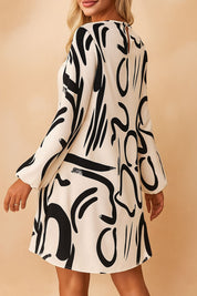 Cream abstract-print mock-neck mini dress with small keyhole fastening and clean back panel — back view.
