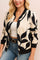 Front detail view of a women’s cream-and-black abstract-print zip-up bomber jacket with rib-knit collar, cuffs and hem; zipper partly open