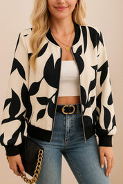Centered front view of the cream-and-black abstract-print zip-up bomber jacket with rib-knit trims and a straight hem; relaxed fit.