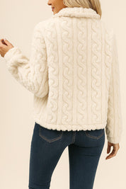 ack view of the cream fuzzy short jacket showing the overall textured pattern and straight hem.