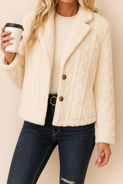 Straight front view of the cream fuzzy short jacket with two-button front and notched lapel.