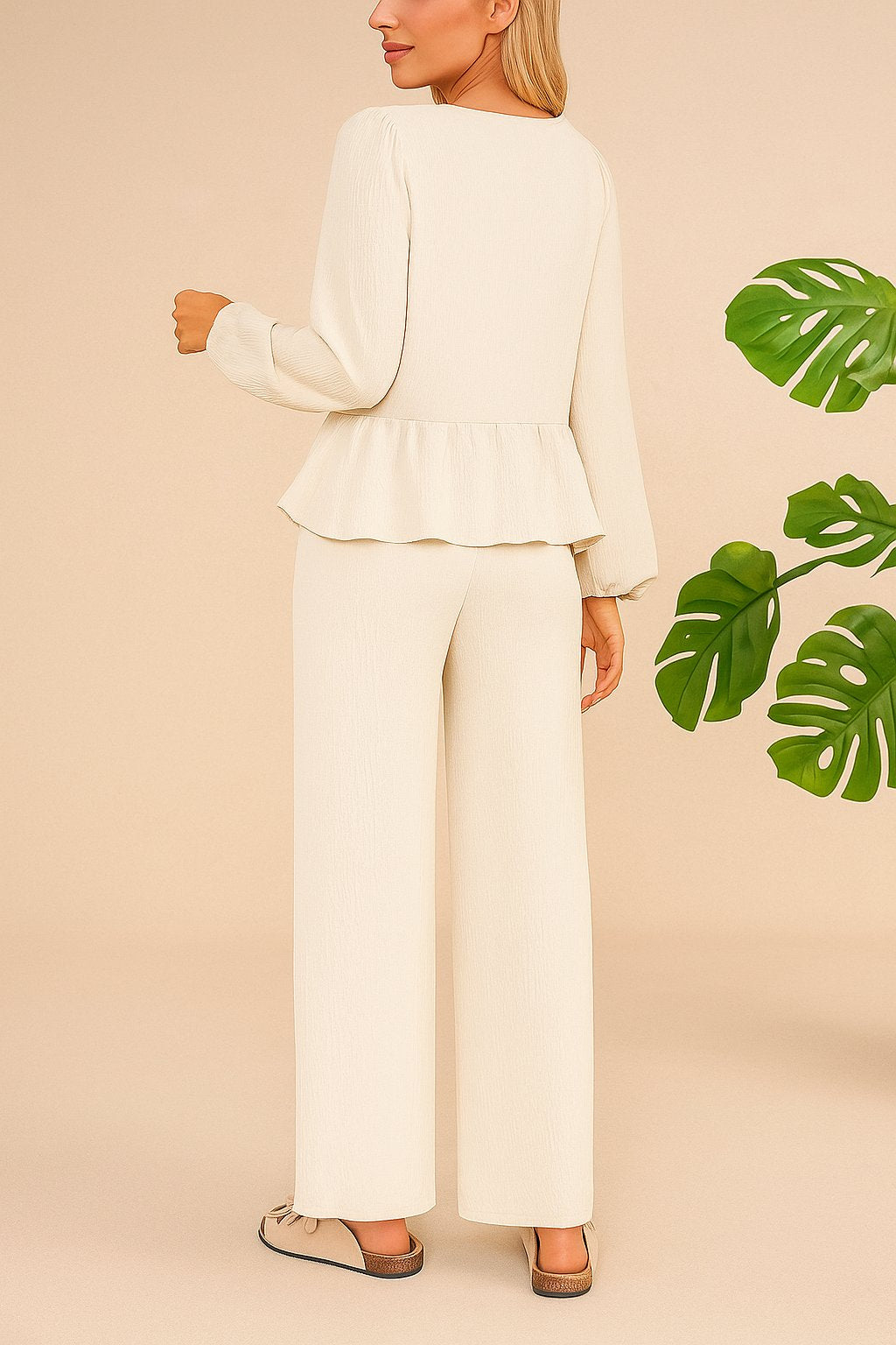 Back view of the cream tie-front peplum blouse and wide-leg pants set; straight back hem and relaxed drape