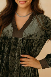 Dark-green velvet mini dress with button cuff and contrast trim on the sleeve — front detail cuff view.
