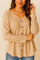 Front detail view of a women’s dust-storm beige V-neck button-front long-sleeve top with drop-shoulder seam and a soft curved hem