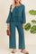Front view of a dusty blue tie-front peplum blouse paired with wide-leg pants; elastic waist and relaxed fit.