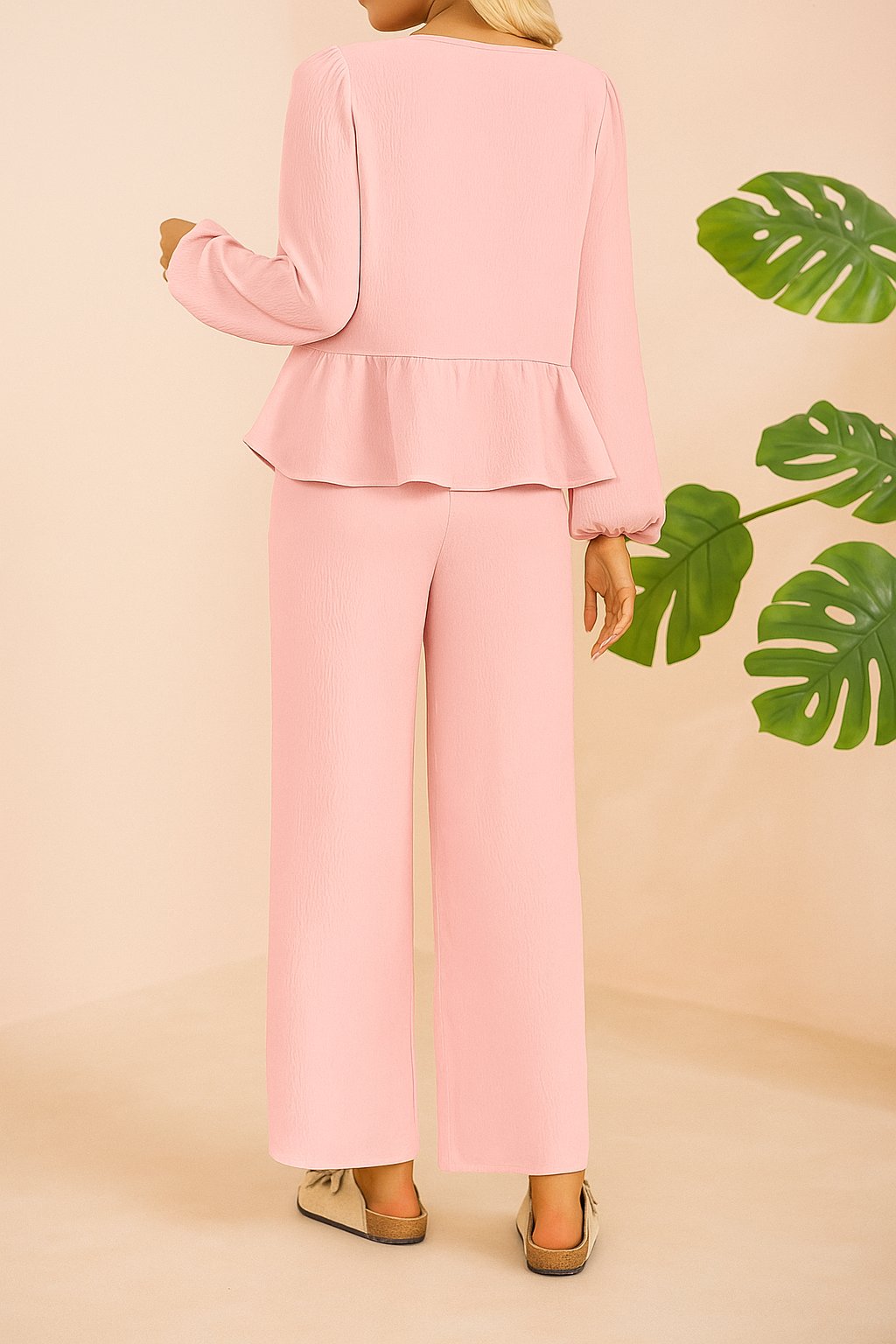 Back view of the dusty pink tie-front peplum blouse and wide-leg pants set.