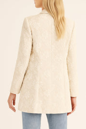 Back view of the eggshell floral jacquard blazer with a clean center seam and straight hem