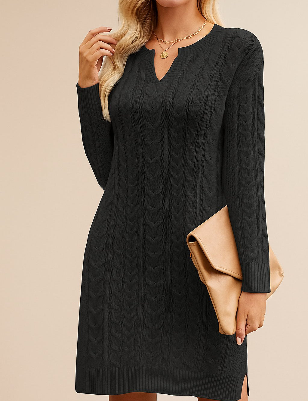 Woman wearing a black cable knit dress with a beige clutch against a beige background