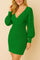 Right side profile of the ribbed wrap sweater dress in emerald green highlighting the deep wrap bodice, cable-knit sleeve and body-skimming fit