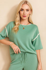 Close front detail of the Gum Leaf lounge top showing the neckline piping and sleeve contrast trim