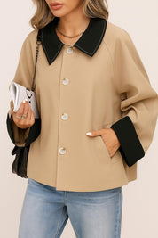 Front detail view of the khaki color-block button-up jacket showing the black contrast shirt collar, button placket, cuff facing and slant welt pocket opening.