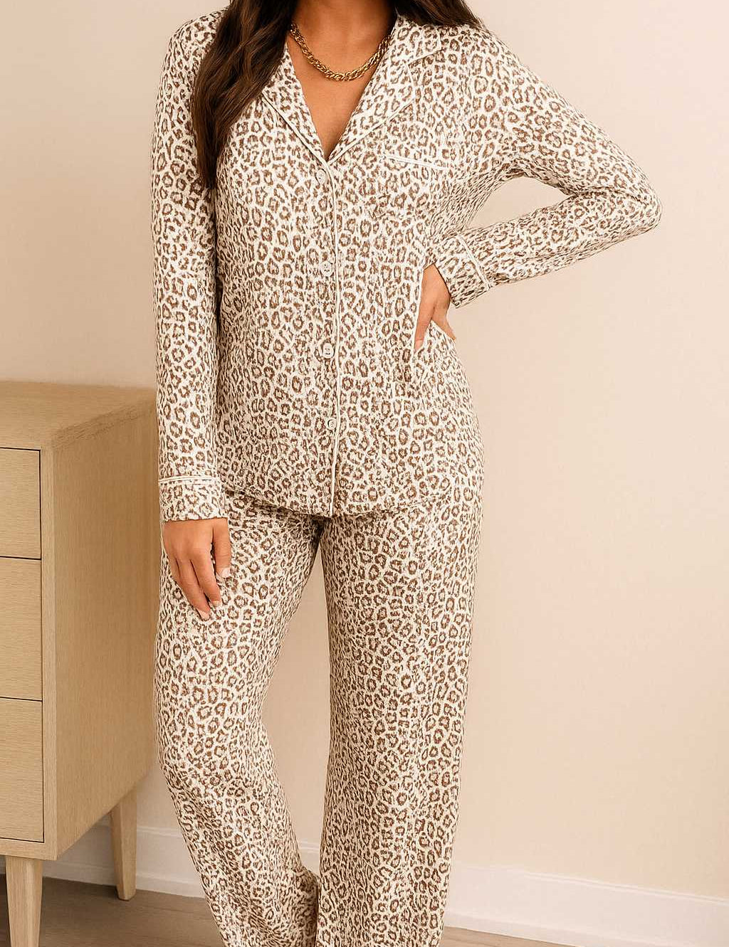 Woman wearing a long sleeve leopard print pajama set with button-down top and matching pants, soft and stylish loungewear