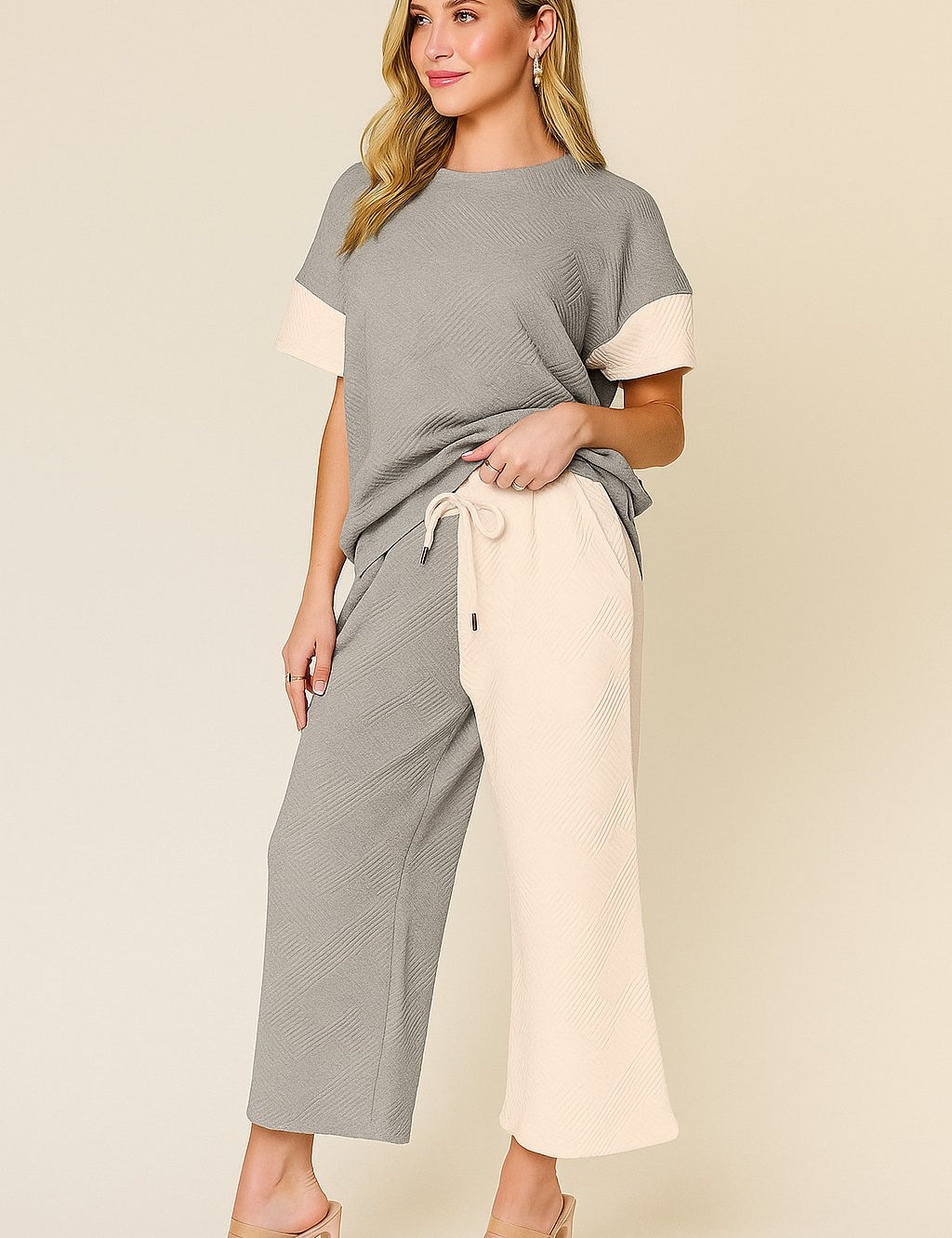 Front view of a light-gray and apricot colorblock textured short-sleeve top with matching wide-leg pants and elastic waist