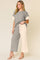 Front view of a light-gray and apricot colorblock textured short-sleeve top with matching wide-leg pants and elastic waist
