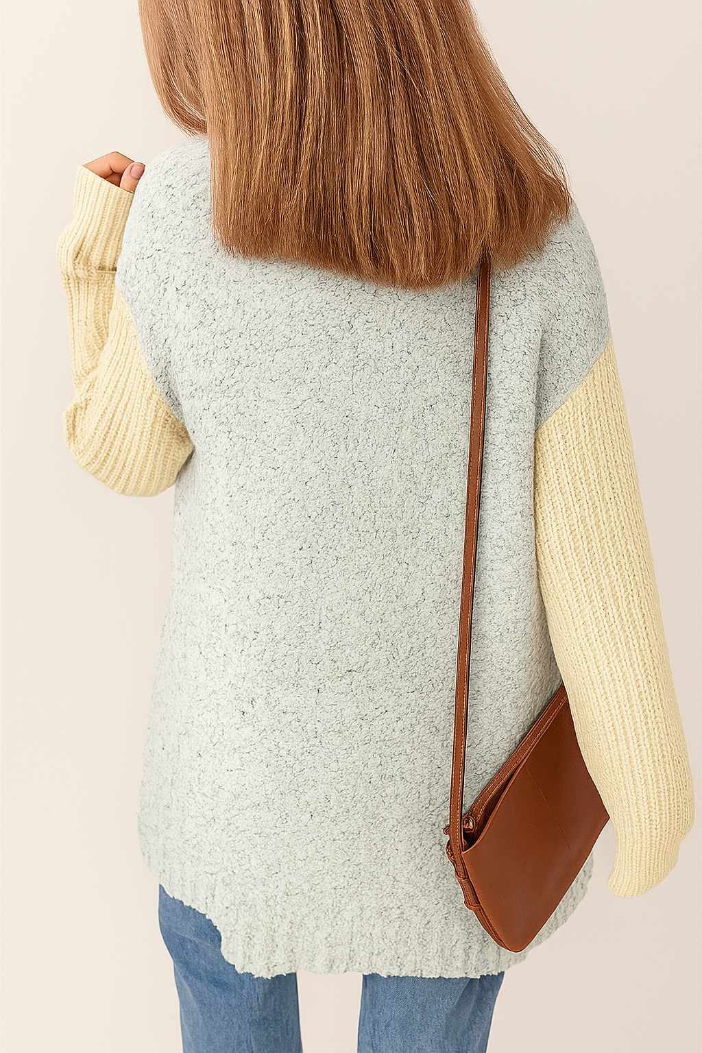 Back view of the light-gray and pastel-yellow colorblock open-front cardigan highlighting the textured knit and ribbed cuffs.
