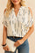 Front view of a women’s multicolor cold-shoulder blouse with a notched V-neck and short sleeves; abstract line print and easy, relaxed drape