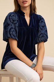 Navy velvet blouse with embroidered puff sleeves, gentle ruffled collar and relaxed back yoke — back view.