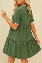 Olive green tiered mini dress with white lace trim and flounce sleeves — back view